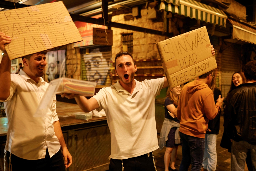 In Jerusalem, Israelis celebrate the death of Hamas leader Yahya Sinwar,  offering free candy as they view it as a major victory in their ongoing conflict